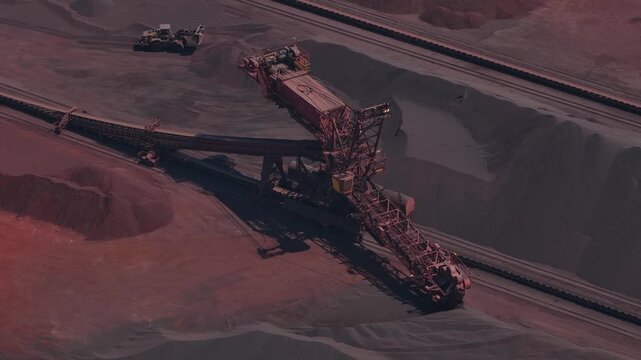 Stacker reclaimer machine moving ore in an open pit mine
