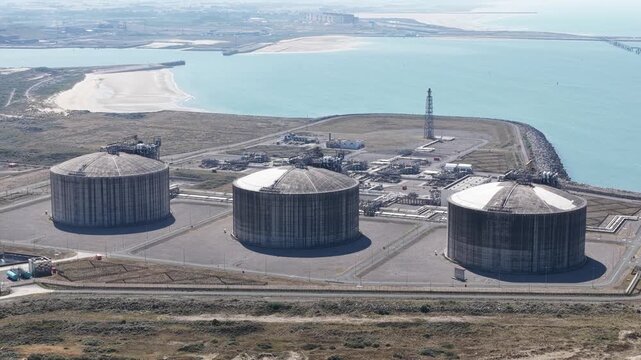 Aerial view of lng terminal industrial gas storage tanks
