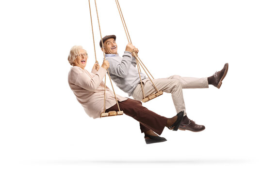 Happy elderly couple swinging on a swing