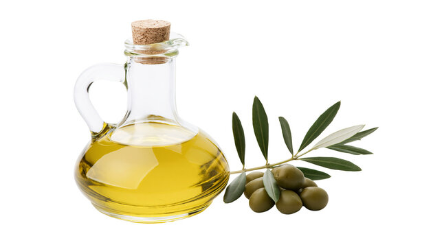 Glass carafe filled with golden olive oil next to fresh olives and leaves