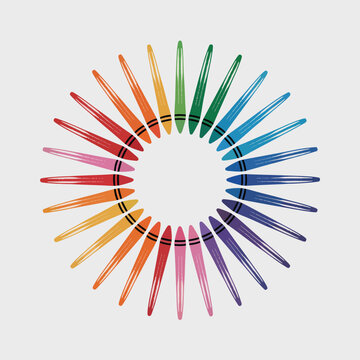 Una disposici&oacute;n circular de crayones de cera coloridos sobre fondo gris claro