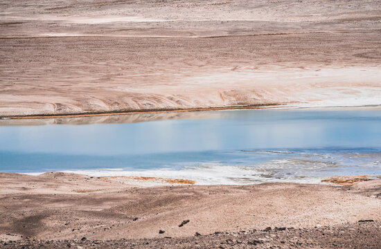 A lake with blue water on a high-altitude rocky plateau in the Pamirs, a mountain landscape with a lake and rocks in the desert, a combination of colors in nature
