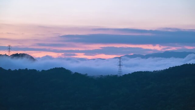 Stunning sunrise view over rolling hills, clouds, and an electricity pylon in Xindian, New Taipei City, Taiwan.