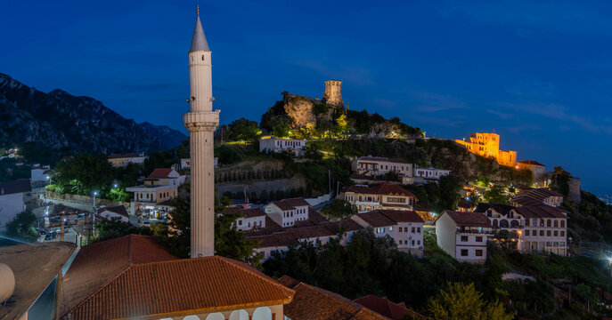 Kruja castle and mosque minaret illuminated at twilight Albania