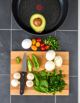 Cooking Preparation with Tomatoes Avocado and Mushrooms Overhead
