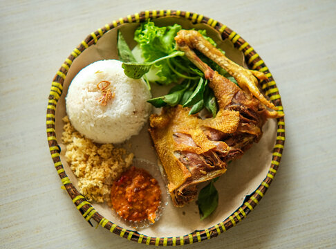 Traditional Indonesian Crispy Duck & Rice Meal. Authentic Asian Fried Chicken with Sambal for Restaurant Menus