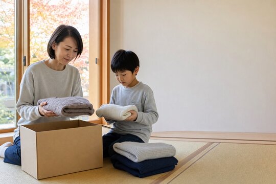 秋の衣類を整理して再利用する日本人の母と息子