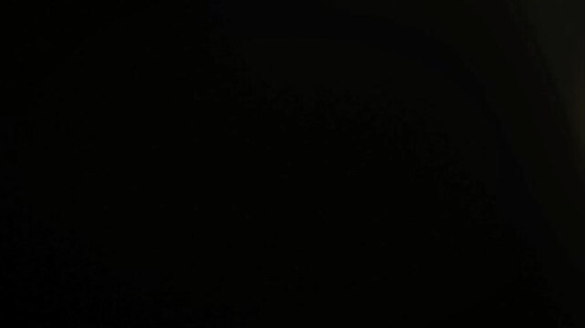 dark texture background with a faint glow on the left side, ambient light effects, subtle gradient, abstract moody atmosphere