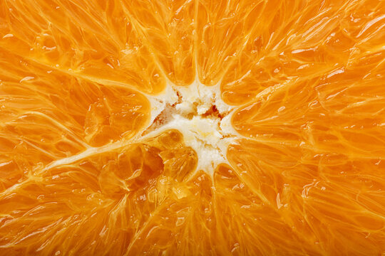 Macro of fresh orange flesh showing juicy citrus texture, natural patterns, and vibrant color, For food backgrounds, nutrition, and healthy lifestyle concepts