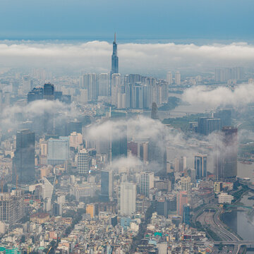 HO CHI MINH CITY, VIETNAM: Dramatic aerial view of Saigon skyline and Landmark 81 emerging from low clouds and morning fog