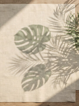 Tropical Monstera and Palm Leaf Shadow on Beige Linen Fabric summer background