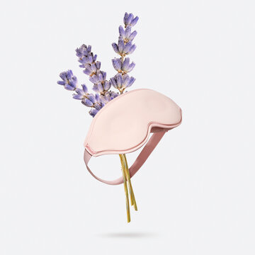 Lavender dried flowers bouquet with pink sleep mask flying on light gray background. Minimalistic creative concept of calm bedtime, deep sleep quality, mind relaxation and aromatherapy. Reduce stress
