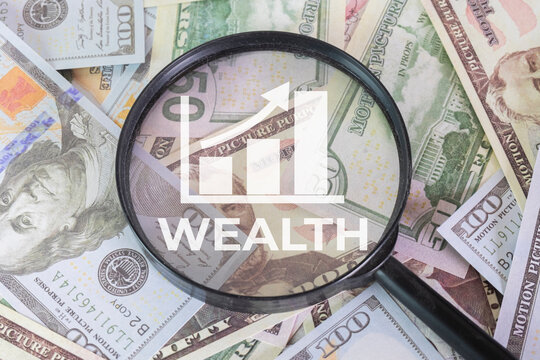 Wealth management and financial growth concept. Magnifying glass focusing on a growing bar chart icon and the word WEALTH over US dollar banknotes. Investment strategy, profit and economy.