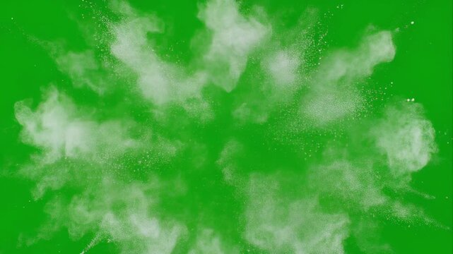 White powder explosion bursts into smoke in slow motion against green screen background