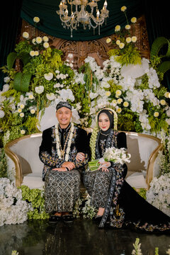 Javanese Traditional Muslim Wedding Couple in Black and Gold Attire