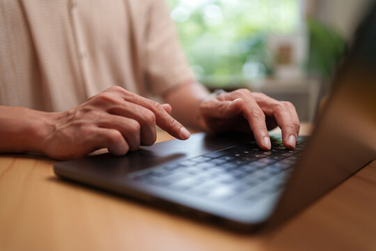 Man types on a laptop to access an online application, highlighting secure registration, digital authentication, remote work, and modern business communication.