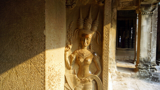 Sacred Hindu Devata goddess sculpture carved from sandstone inside Angkor Wat