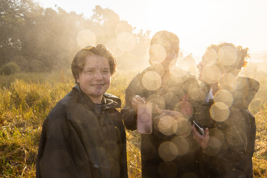 rain drops obscuring family at edge of Victoria Falls, Zambia, Africa
