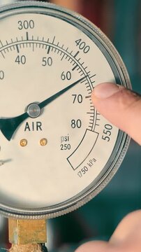Pressure Gauge Instrument Close-up. Macro shot of a circular pressure gauge showing air unit measurements.