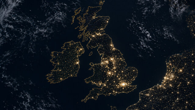 Nighttime satellite-style view of the British Isles showing glowing borders, major metropolitan areas and dark surrounding seas.