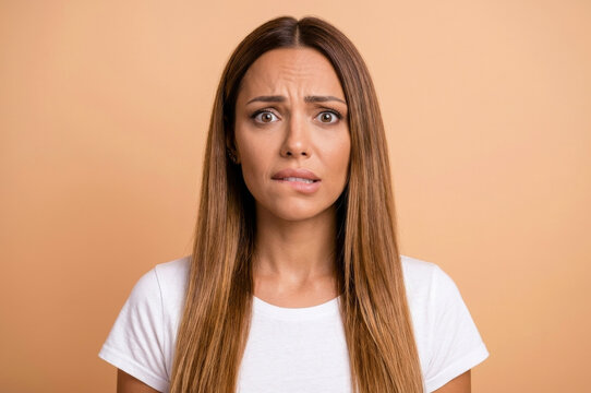 An expressive close-up capturing a woman's moment of visible concern and confusion