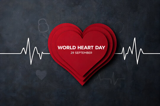 World heart day layered red heart with electrocardiogram on dark chalkboard background design for health awareness