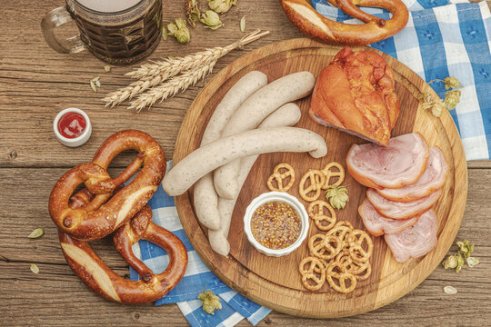 Traditional Oktoberfest set. Pretzels, beer, weisswurst, eisbein with mustard. German festival food