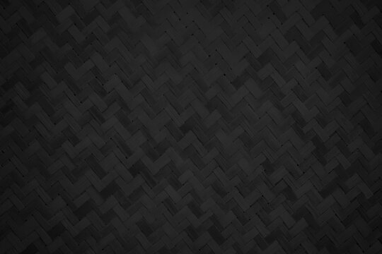 Old black bamboo weave texture background, pattern of woven rattan mat in vintage style.