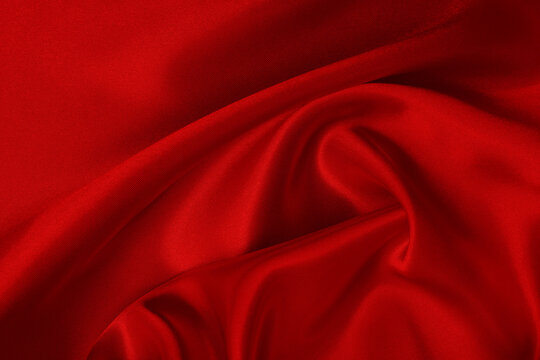 Dark red fabric texture background, detail of silk or linen pattern.