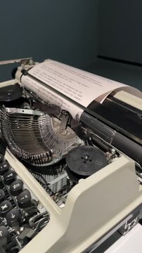 vintage mechanical typewriter with a sheet of paper in the carriage, revealing metal keys and moving writing mechanism in a nostalgic creative workspace