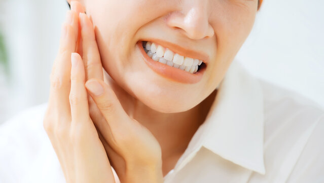 Middle-aged woman with back tooth pain. Cavity, wisdom tooth, dental care, dentist, pain, stress, trouble, concern, treatment.