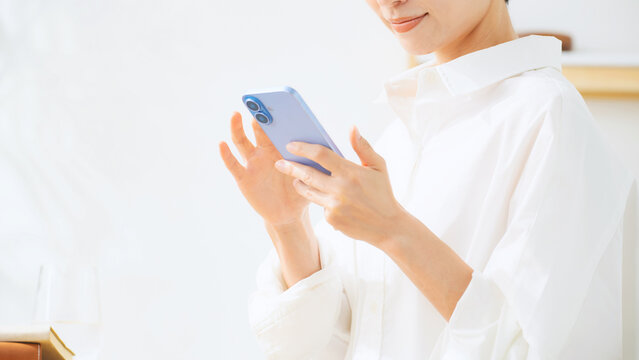 Middle-aged woman using a smartphone. Apps, social media, videos, smartphone, mobile, email, casual, mobile phone.
