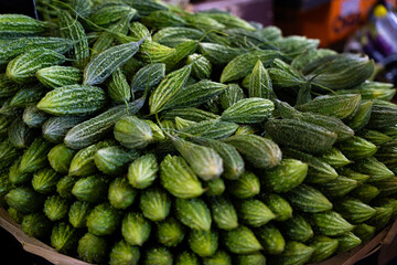 Fresh bitter melon at market © ProShine Studio
