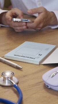 Doctor Approving Electronic Prescription for Medication Refill. Vertical shot