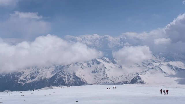 Climbers on the slopes of Mount Elbrus with the Semerka Glacier and Mount Ushba in the background