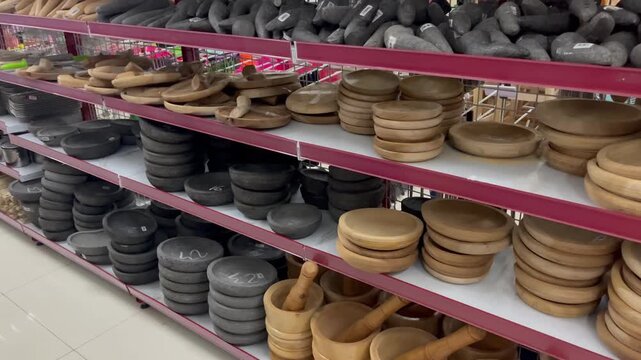 Row of Handmade Wooden Plates and Stone Grinders at Craft Market