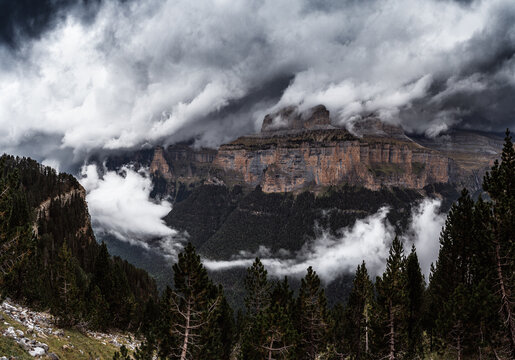 Storm clouds clearing over limestone cliffs in Ordesa y Monte Perdido National Park, Pyrenees, Huesca, Spain