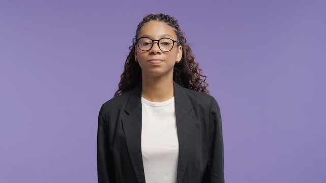 Confused young african woman shrugging with raised shoulders and open hands. College student expressing uncertainty, doubt and lack of an answer.