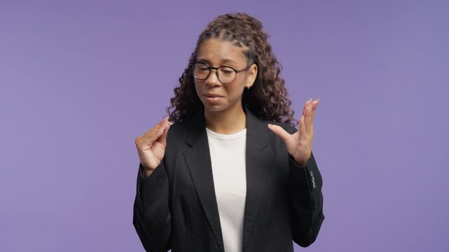 Annoyed young african woman making a blah blah gesture with her hand. College student expressing sarcasm, empty promises, gossip, criticism and disbelief.
