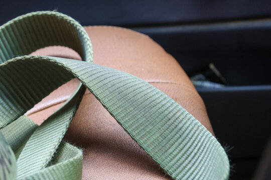 Green nylon strap texture close up on leather seat with soft lighting and calm mood