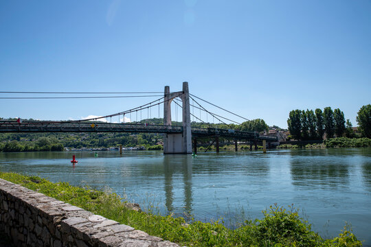 Suspension Bridge Over the rhone River With Green Riverbank near condrieu