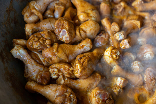 Marinated chicken drumstick raw chicken drumstick poultry meat marinade cooking pan spice brown sauce simmering steam