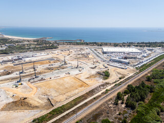 Fototapeta premium Data center building and expansion site under construction near the coastline in Portugal. Atlantic ocean. Aerial view