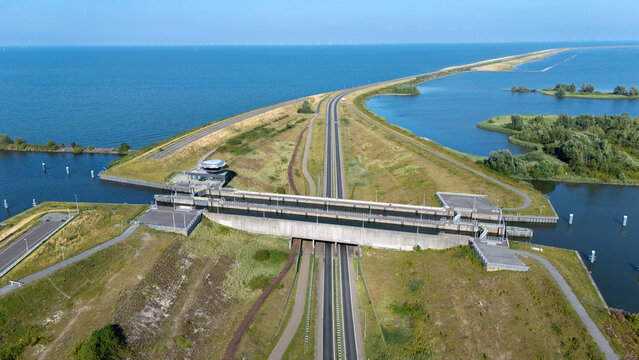 Aerial view of Naviduct Krabbersgat with the dike, road and surrounding water in the Netherlands. Drone photograph showing Dutch water infrastructure, lock system, causeway and landscape from above.