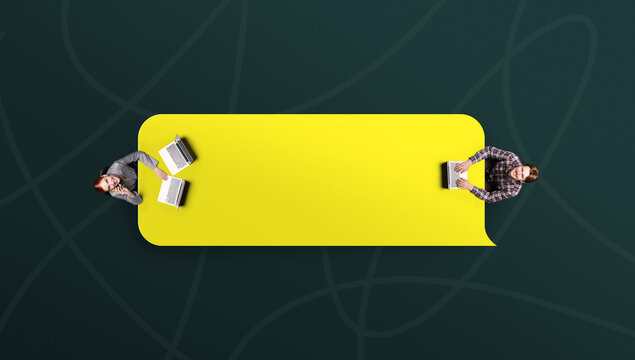 Two people working across yellow speech bubble on dark abstract background. Concept of business negotiation, collaborative problem solving, creative teamwork.