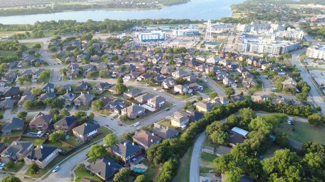 Private swimming pools punctuate residential lawns bordering natural tree belts near Lewisville Lake in Lakewood Estates. Modern suburban lifestyle infrastructure documents in Little Elm, DFW