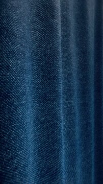 Vertical 3D render of blue denim fabric with soft draping folds, seamless loop texture animation for fashion, mobile and stories content