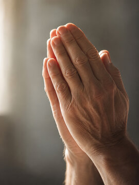 Close-up view of hands clasped together in prayer, evoking a sense of calmness and introspection.