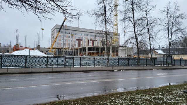 Construction site in winter with cranes working on a new building in a city