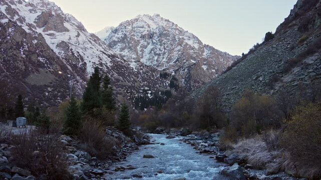 Mountain River Flowing Through Rocky Valley with Snow Capped Peaks in Ala Archa National Park Central Asia